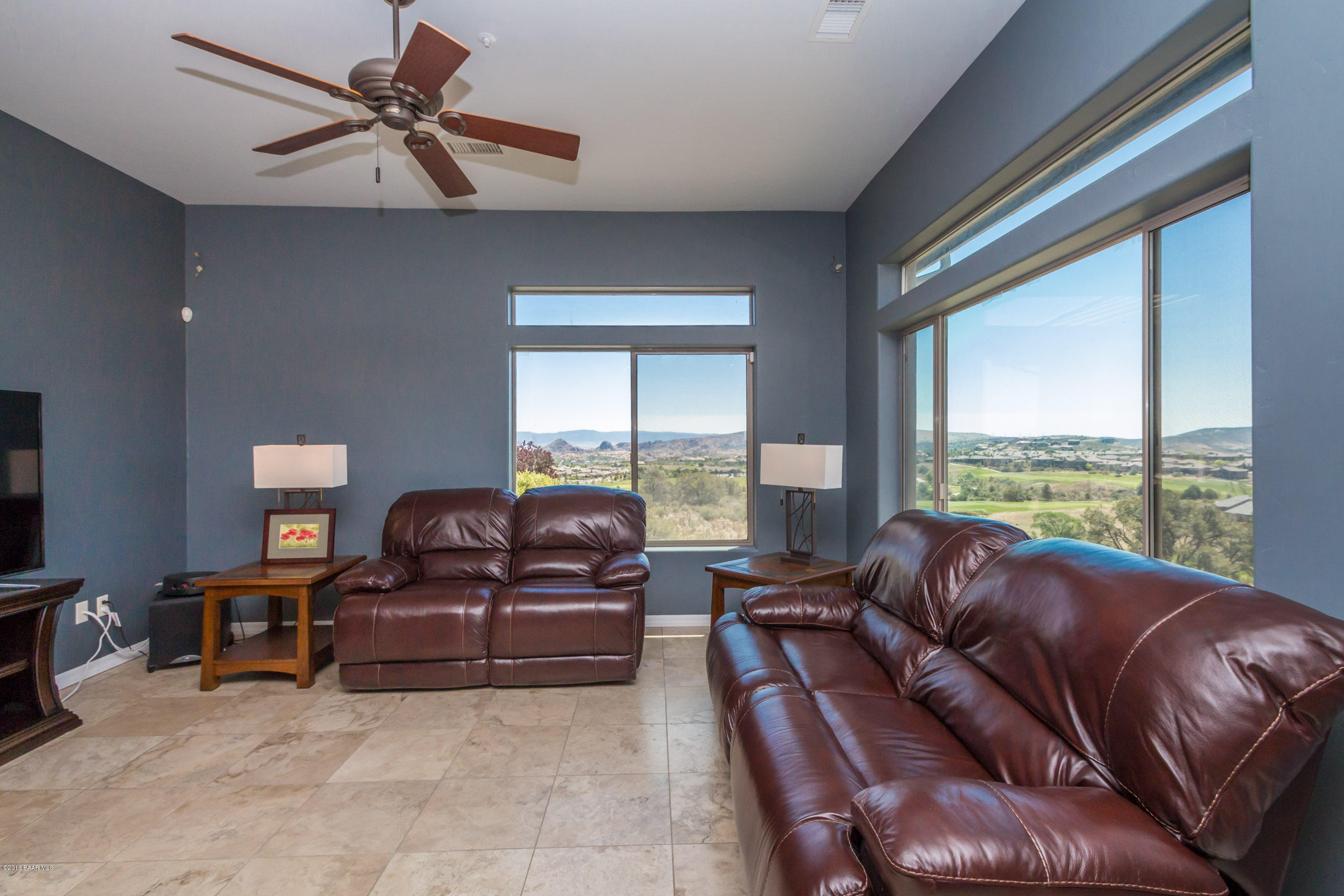1055 Vantage Point Circle Prescott, AZ 86301 - Photo 4 of 38 a living room with furniture ceiling fan and a large window