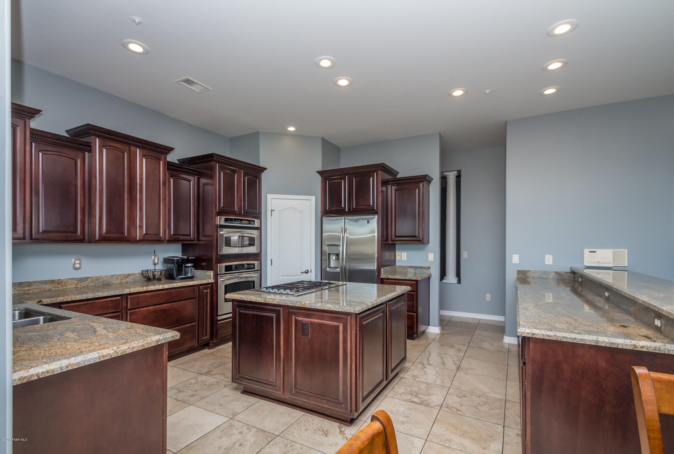 1055 Vantage Point Circle Prescott, AZ 86301 - Photo 7 of 38 a kitchen with stainless steel appliances granite countertop a sink stove and refrigerator