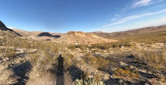 a view of a mountain range in a cloudy sky