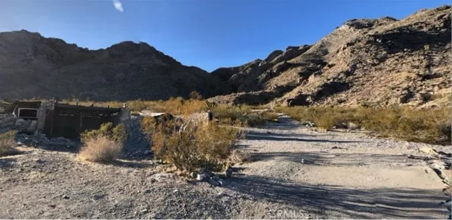 a view of a yard with wooden fence