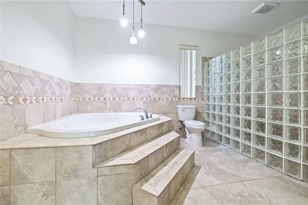 a bathroom with a bathtub and toilet