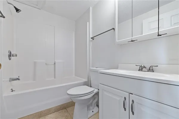 a bathroom with a sink toilet vanity and bathtub