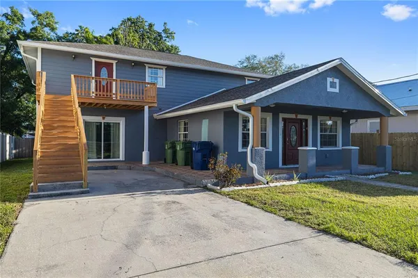 a front view of a house with a yard and porch