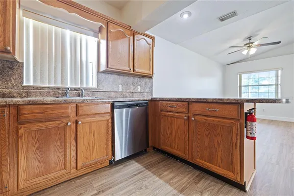 a kitchen with granite countertop cabinets stainless steel appliances and a sink