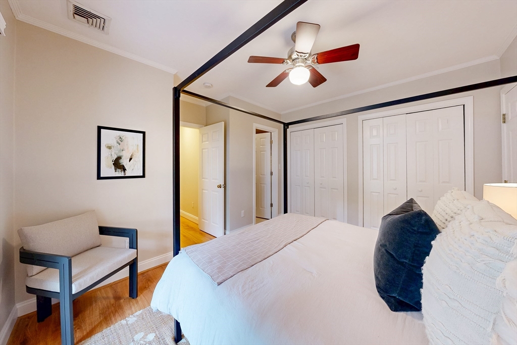 111 West 8th Street, Unit C Boston, MA 02127 - Photo 12 of 22 a bed room with a bed and a chandelier