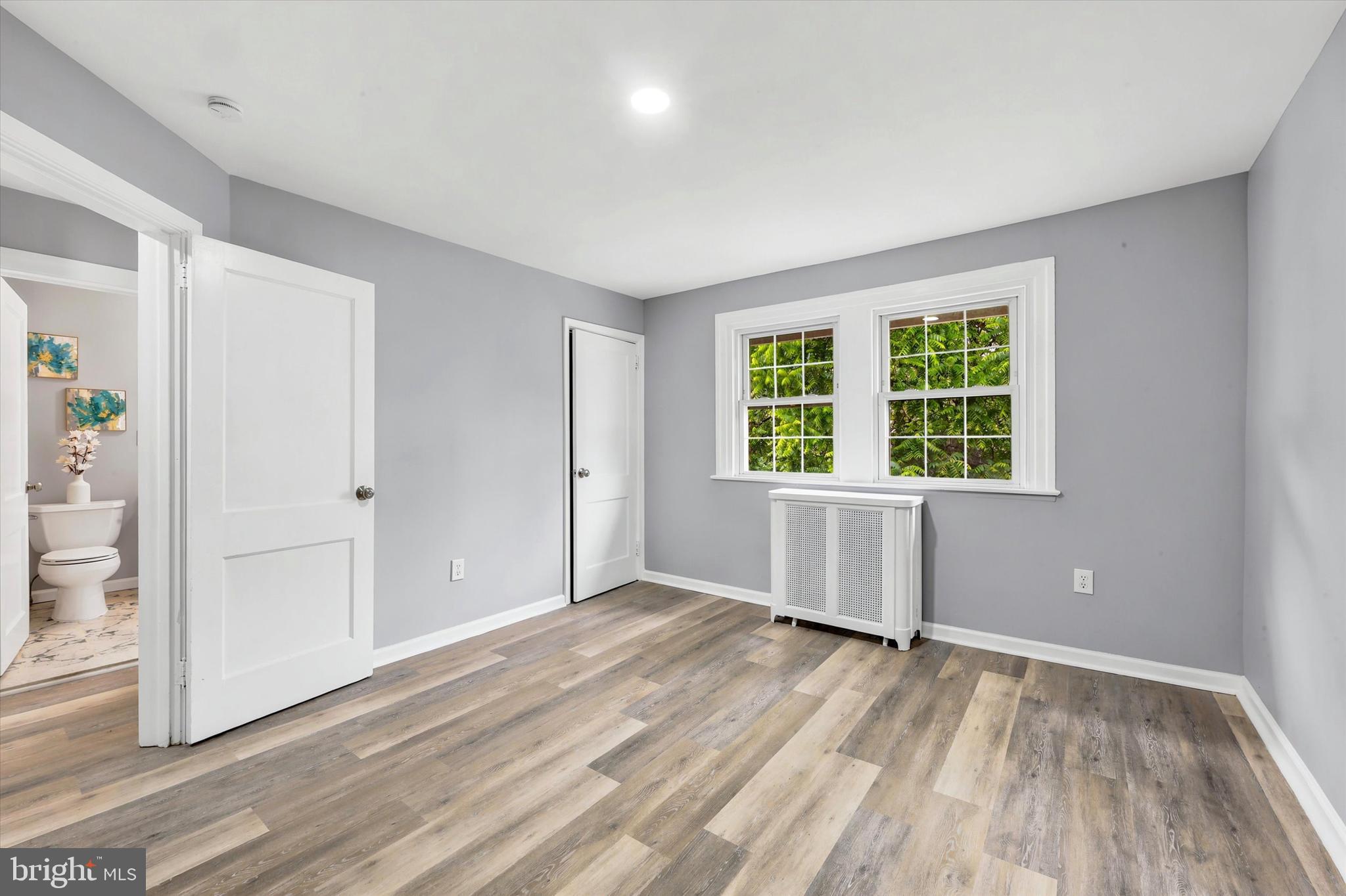 7208 Hilltop Road Upper Darby, PA 19082 - Photo 17 of 28 an empty room with wooden floor and windows