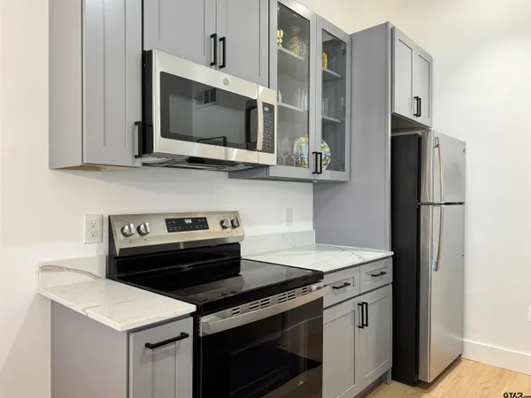 a kitchen that has a cabinets and a stove top oven