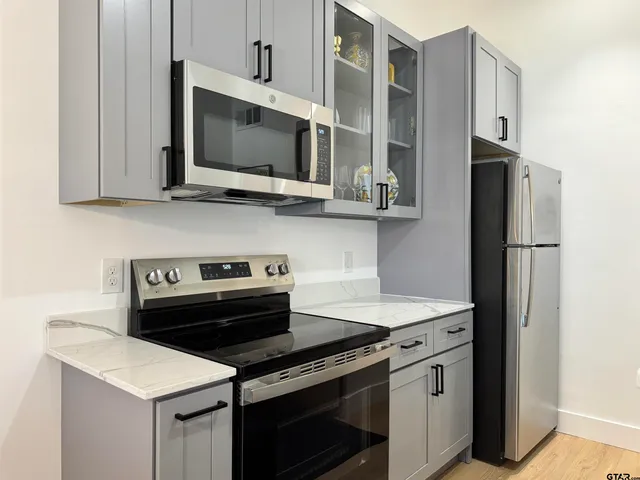 a kitchen that has a cabinets and a stove top oven