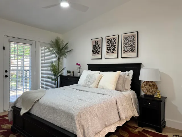 a bedroom with a large bed and a window