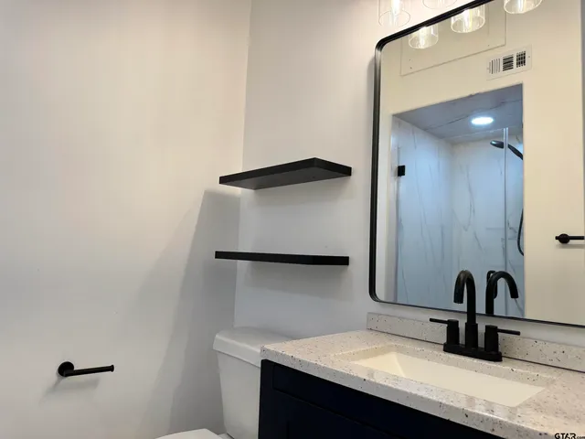 a bathroom with a glass shower door