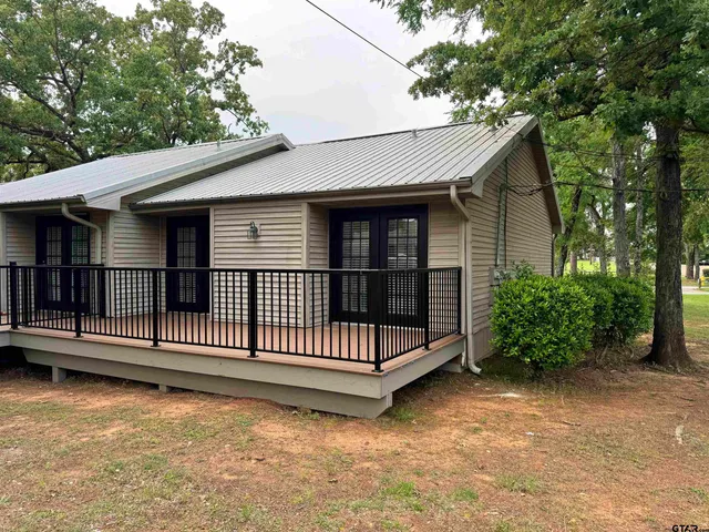 a view of three trees and grass