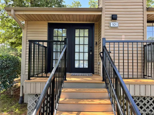 a living room with furniture a couch and a flat screen tv