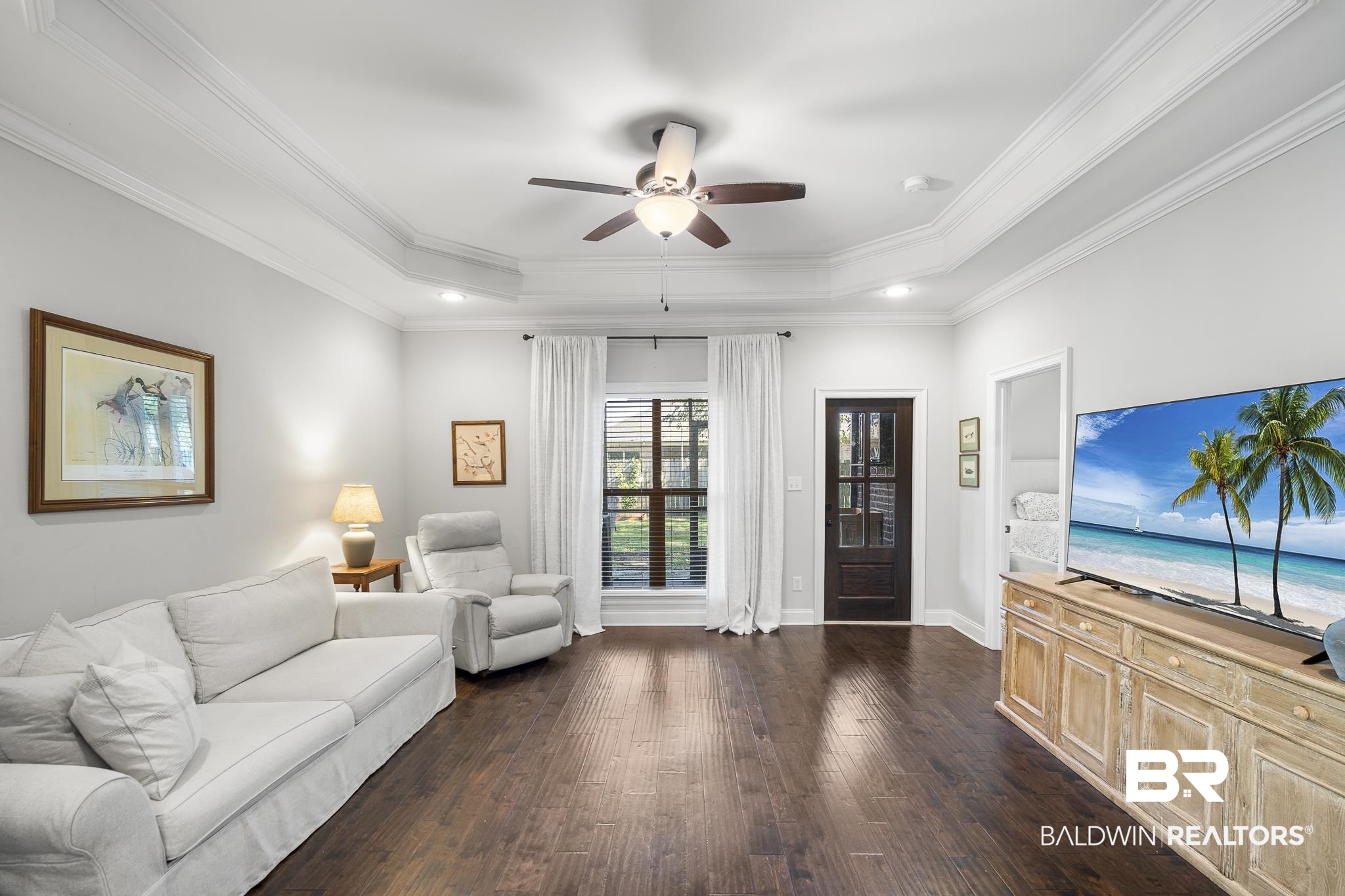 8594 Rosedown Lane Daphne, AL 36526 - Photo 12 of 30 Living room featuring ceiling fan, a raised ceiling, crown molding, wood flooring, and recessed lighting