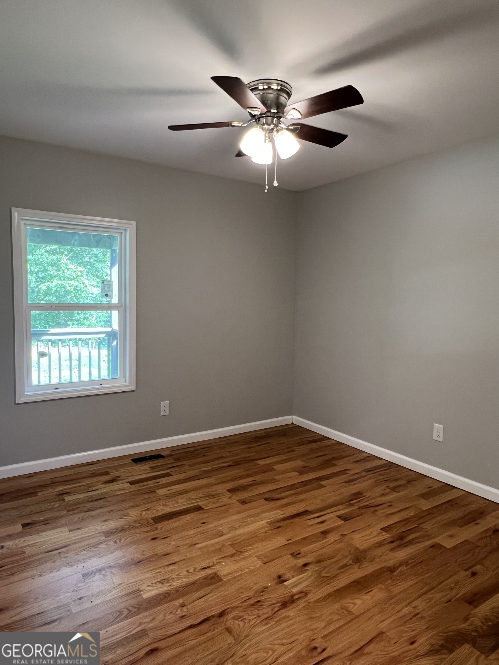 984 Plowshare Road Carrollton, GA 30117 - Photo 9 of 15 a view of an empty room with wooden floor and a window