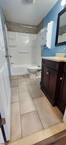 a bathroom with a sink a toilet and vanity
