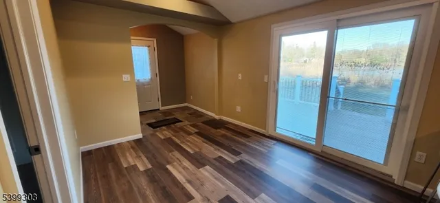a view of a room with wooden floor