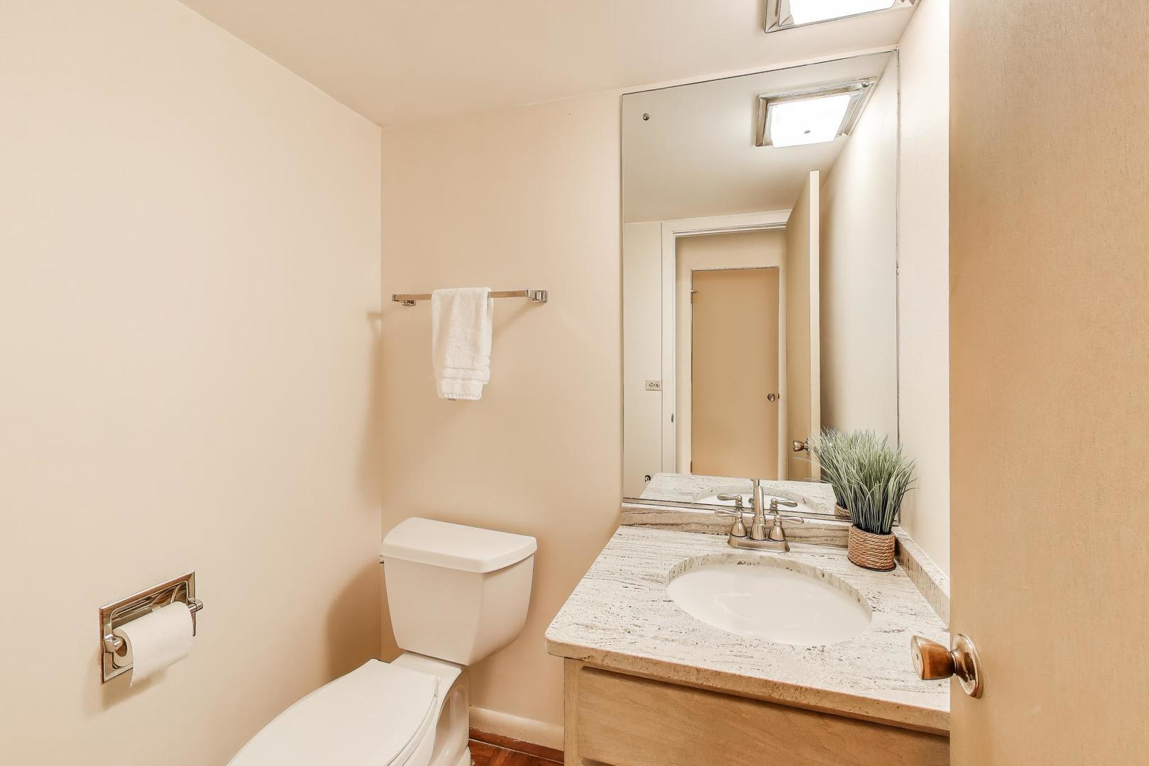 1904 Birch Road Northbrook, IL 60062 - Photo 12 of 37 a bathroom with a granite countertop sink mirror and a toilet