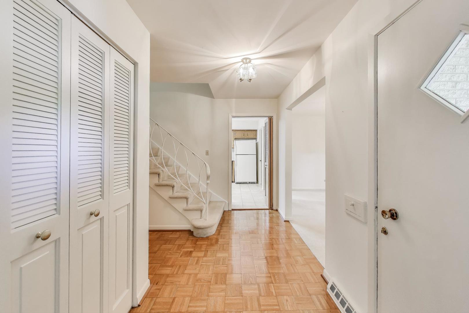 1904 Birch Road Northbrook, IL 60062 - Photo 2 of 37 a view of a hallway with wooden floor and staircase