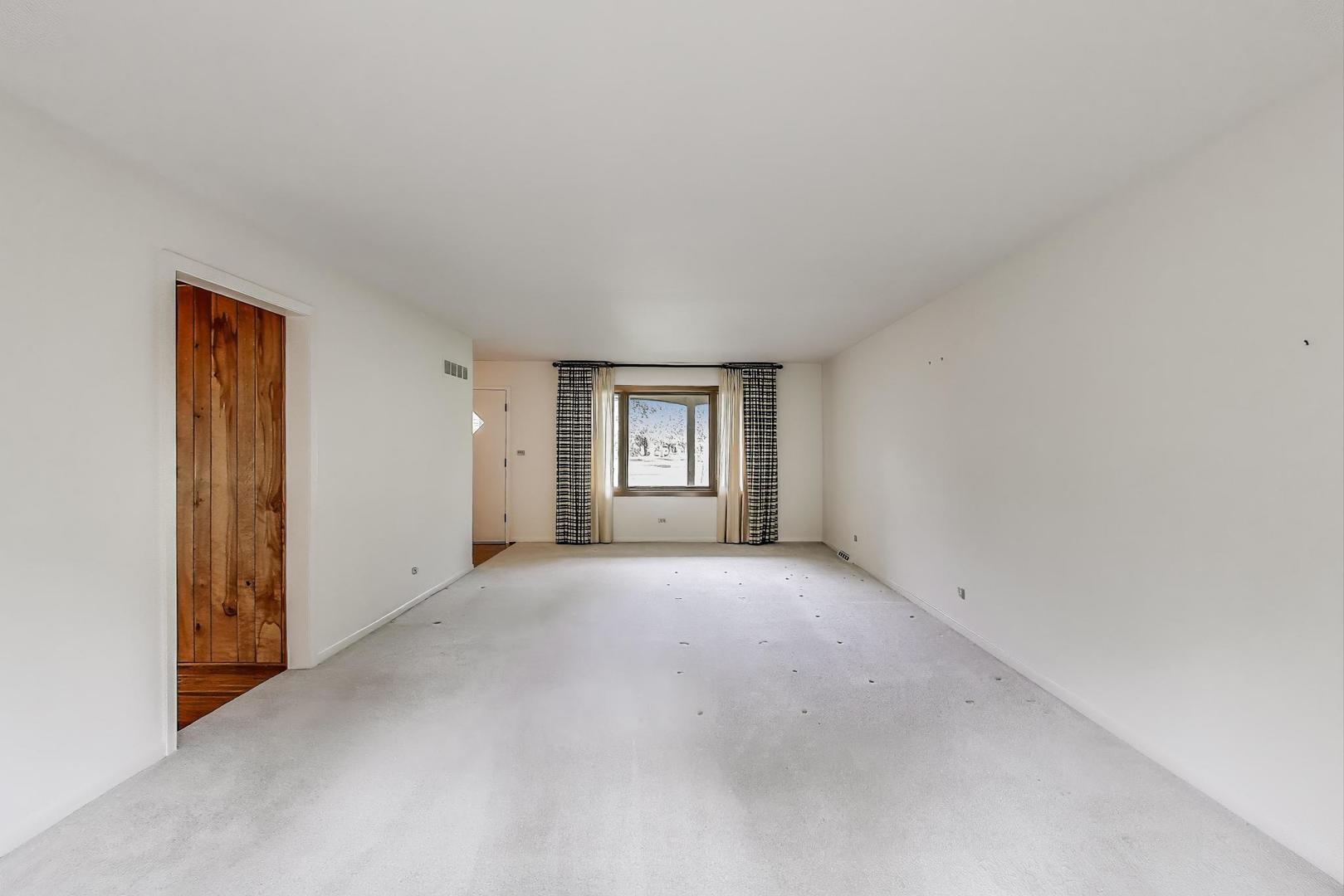 1904 Birch Road Northbrook, IL 60062 - Photo 3 of 37 an empty room with a window and closet area