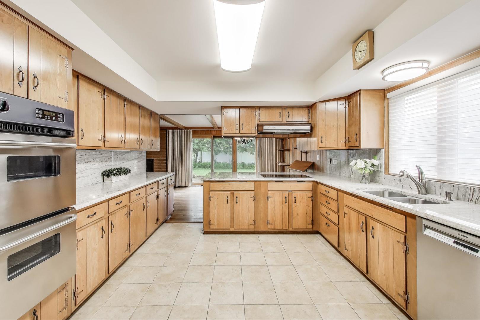 1904 Birch Road Northbrook, IL 60062 - Photo 6 of 37 a kitchen with stainless steel appliances granite countertop a sink and cabinets