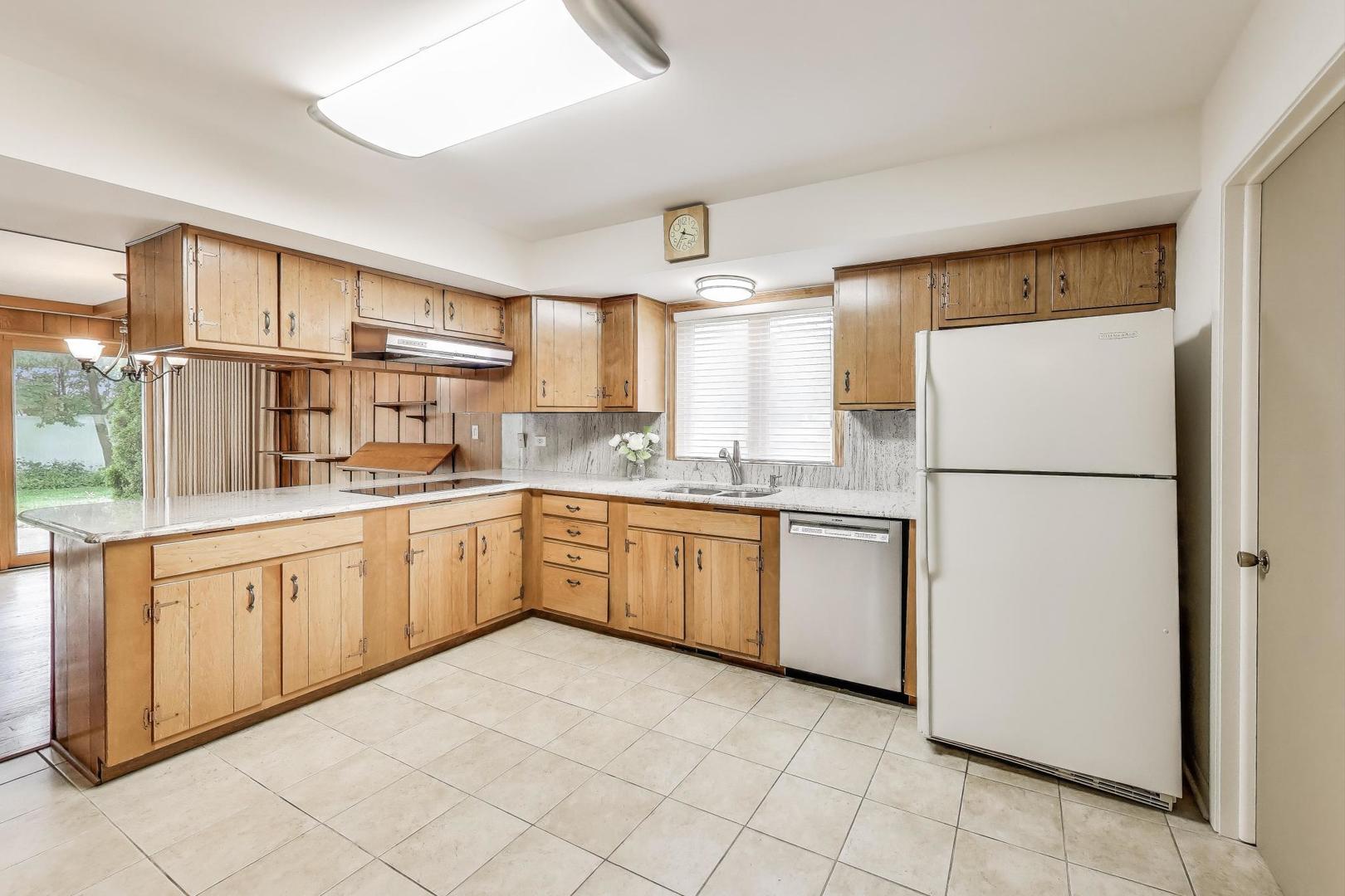 1904 Birch Road Northbrook, IL 60062 - Photo 7 of 37 a kitchen with a refrigerator a sink and cabinets