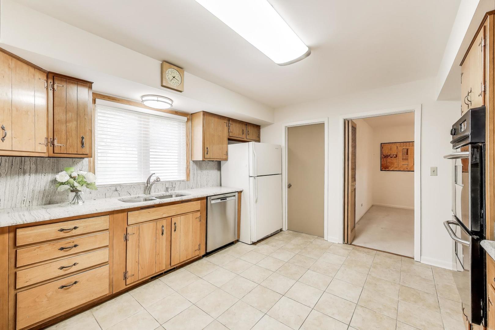 1904 Birch Road Northbrook, IL 60062 - Photo 8 of 37 a kitchen with granite countertop a refrigerator and a sink