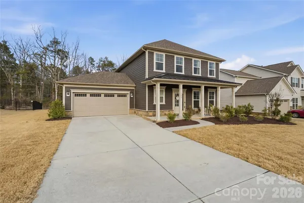 a front view of a house with yard and garage