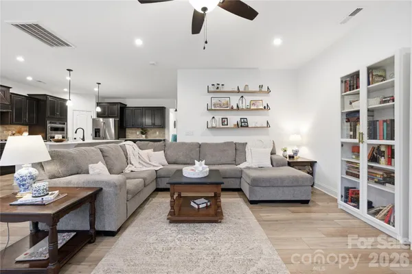 a living room with furniture or couch and a bookshelf