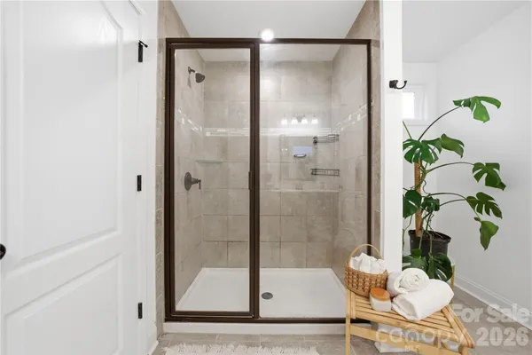 a bathroom with a shower and a sink