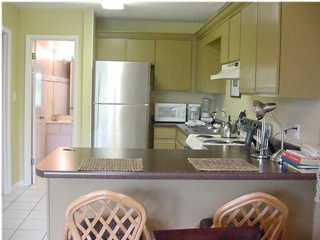 3799 Hwy Santa Rosa Beach, Unit 4C C30A Santa Rosa Beach, FL 32459 - Photo 1 of 3 a kitchen with kitchen island granite countertop a sink a stove and a refrigerator