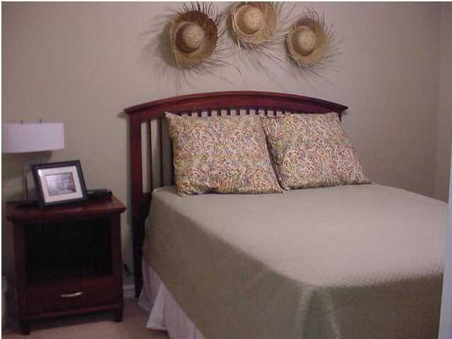 3799 Hwy Santa Rosa Beach, Unit 4C C30A Santa Rosa Beach, FL 32459 - Photo 2 of 3 a bed sitting in a room next to a lamp
