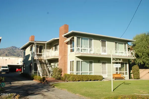 a front view of a house with outdoor seating