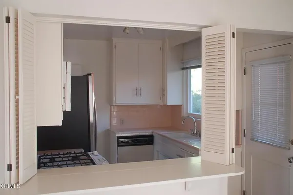 a kitchen with granite countertop a refrigerator and a stove