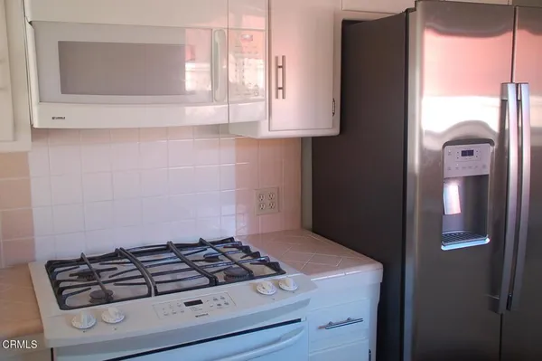 a kitchen with a stove and a microwave