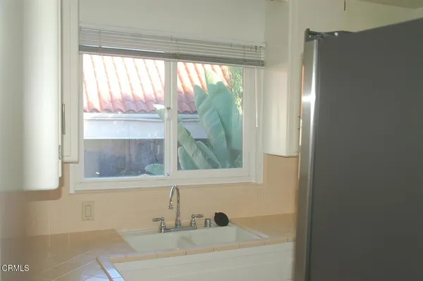 a bathroom with a bathtub and a window