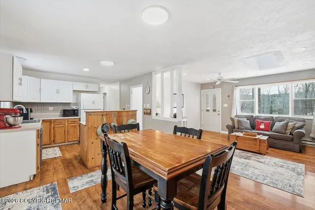 a view of a dining room with furniture and wooden floor