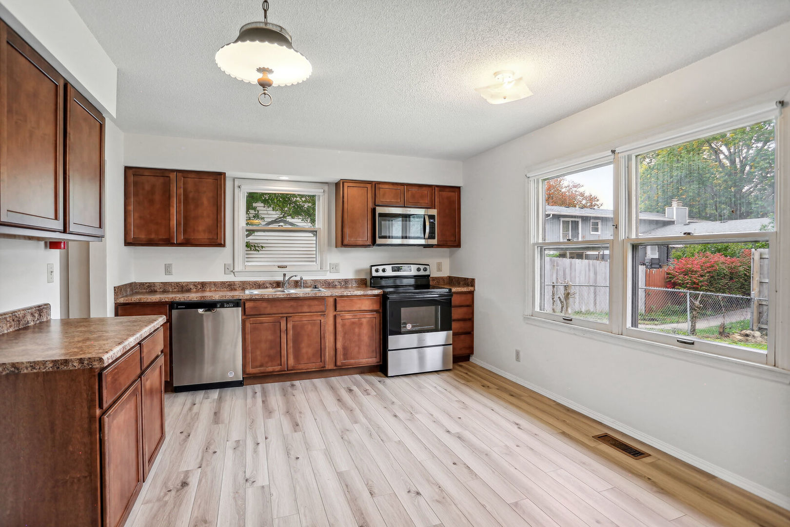 2307 Aspen Drive Champaign, IL 61821 - Photo 16 of 26 a kitchen with stainless steel appliances kitchen island granite countertop a stove a sink and a refrigerator