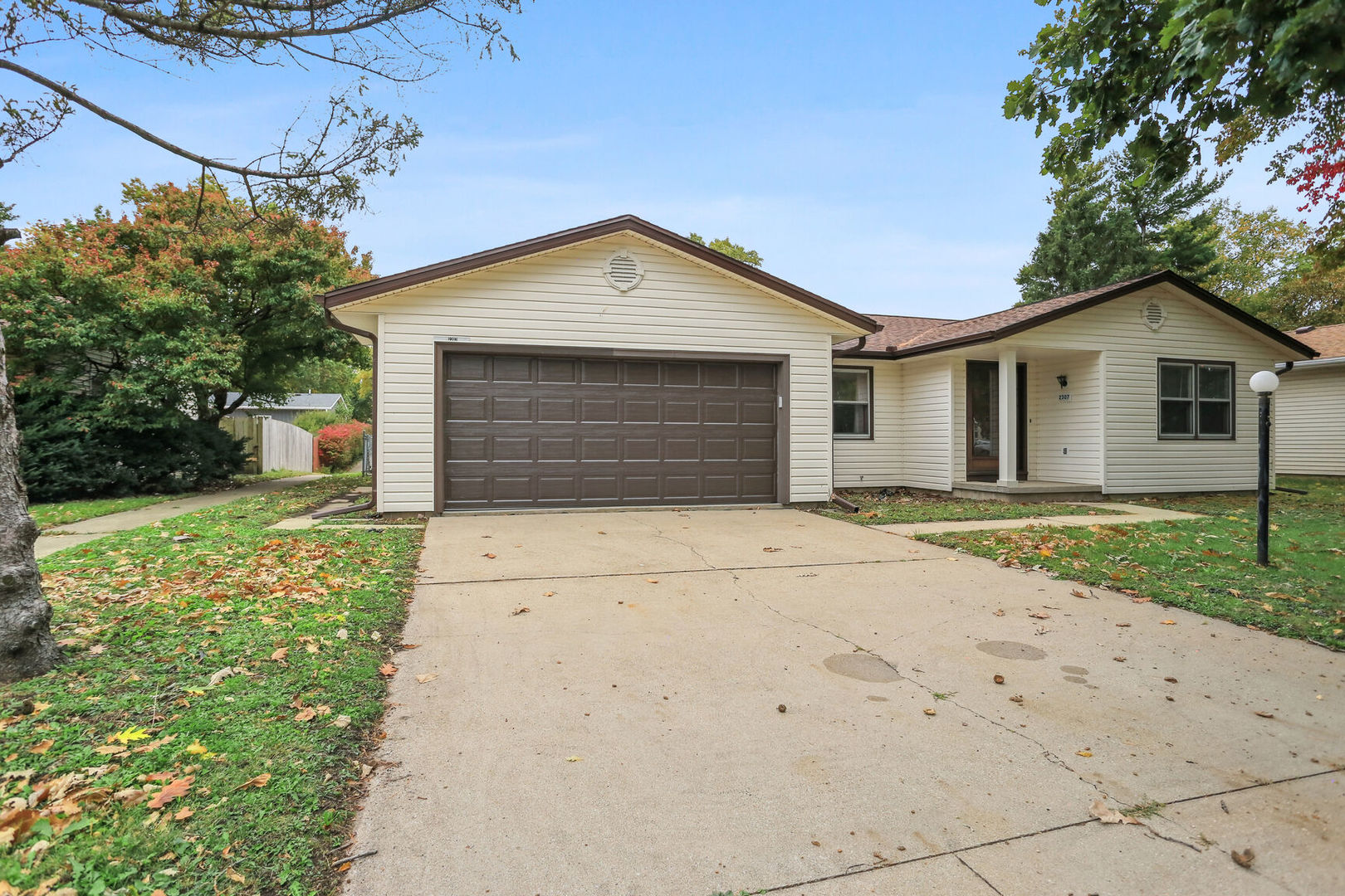 2307 Aspen Drive Champaign, IL 61821 - Photo 2 of 26 a front view of a house with a yard and garage
