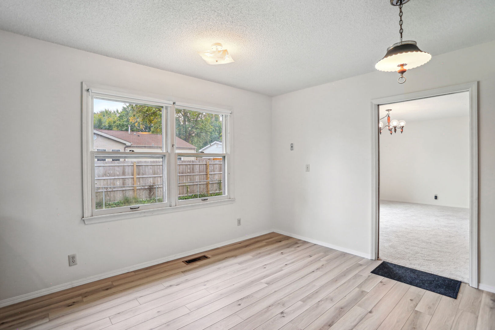 2307 Aspen Drive Champaign, IL 61821 - Photo 21 of 26 an empty room with wooden floor and windows
