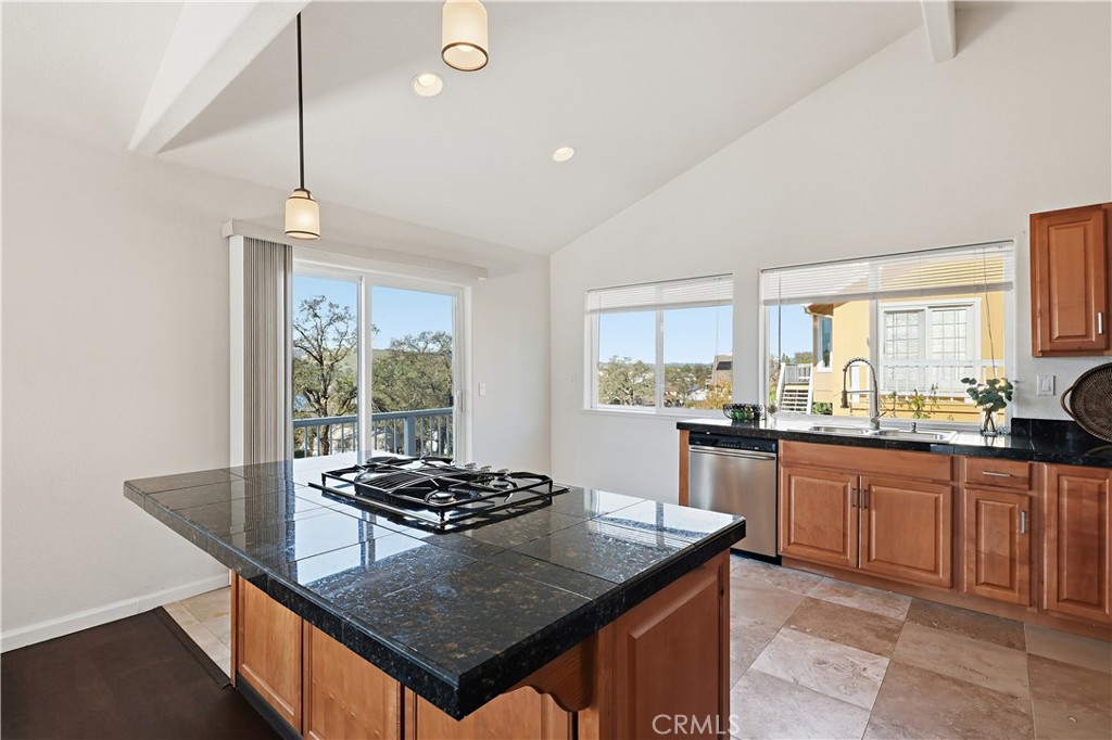 629 Poker Flat Road Copperopolis, CA 95228 - Photo 16 of 71 a kitchen with a stove a sink dishwasher a kitchen island with wooden cabinets and floor