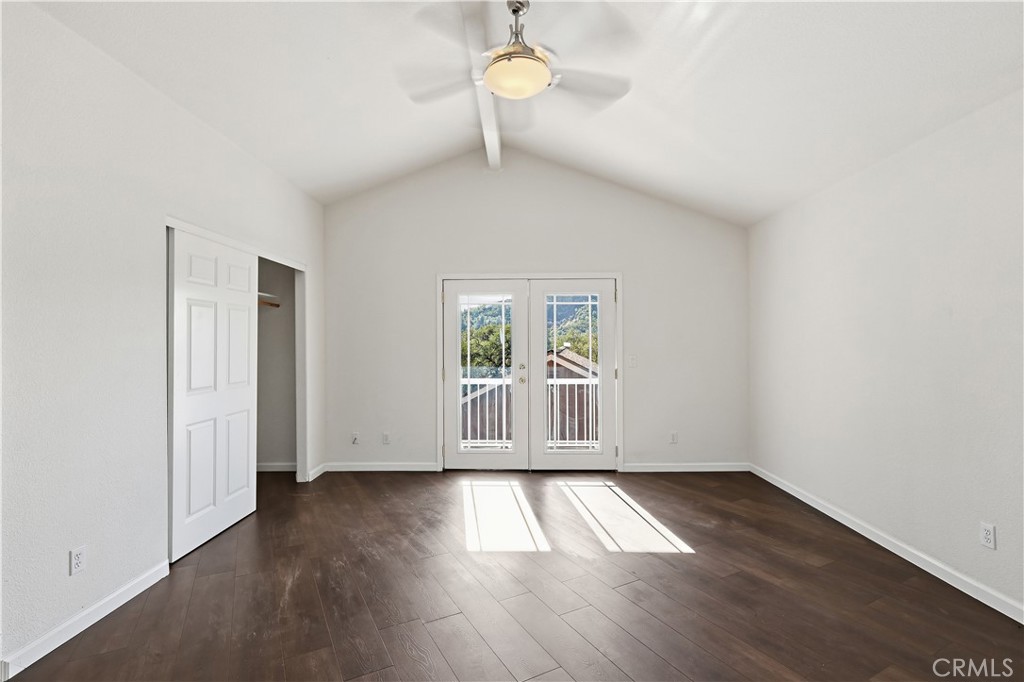 629 Poker Flat Road Copperopolis, CA 95228 - Photo 25 of 71 an empty room with wooden floor and windows