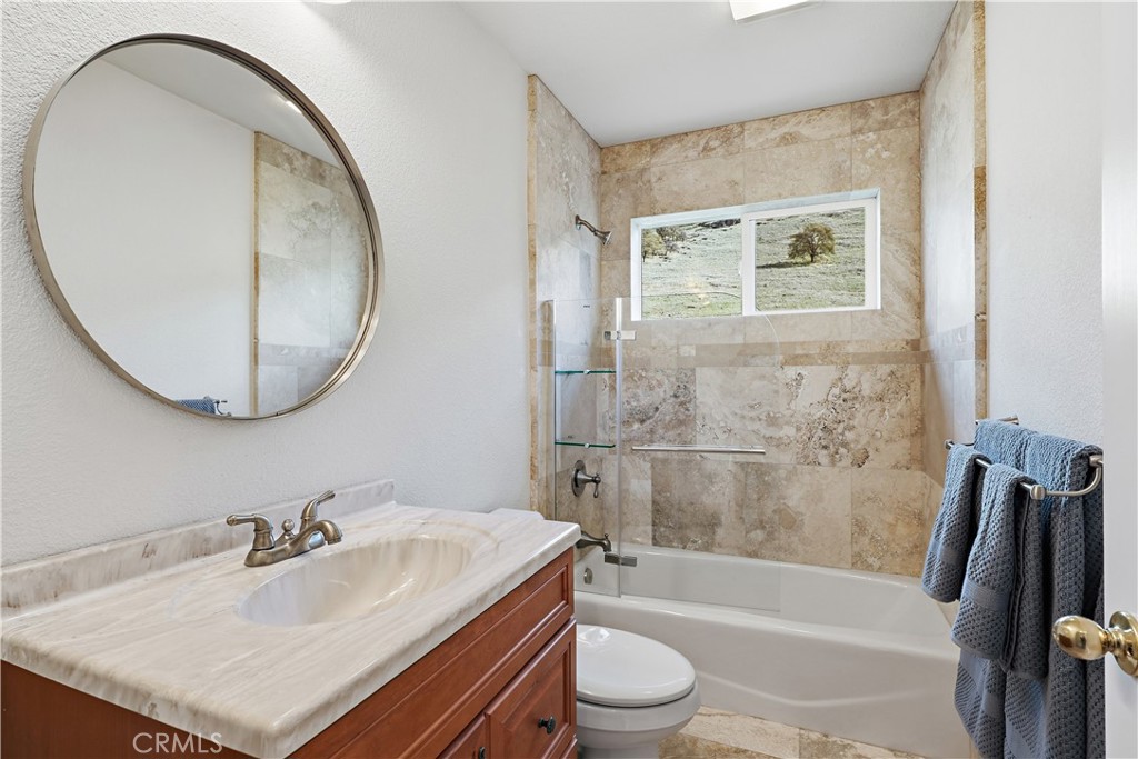 629 Poker Flat Road Copperopolis, CA 95228 - Photo 37 of 71 a bathroom with a sink a toilet and a mirror