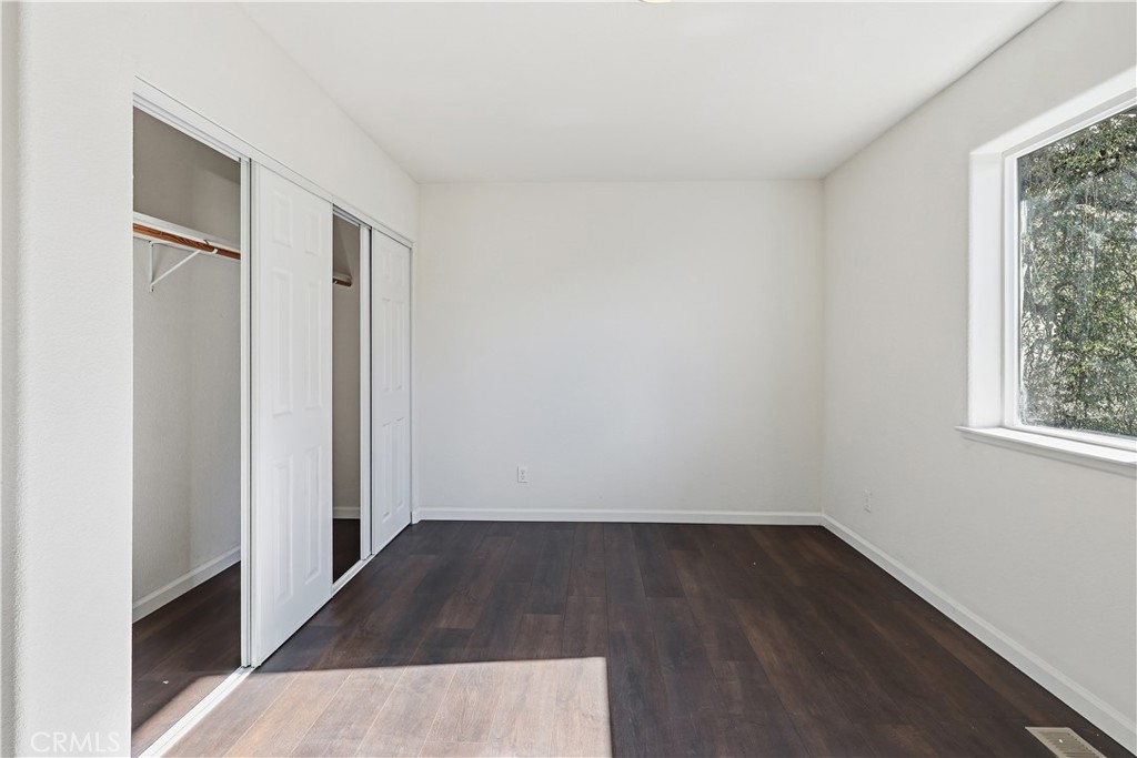 629 Poker Flat Road Copperopolis, CA 95228 - Photo 41 of 71 an empty room with wooden floor and window