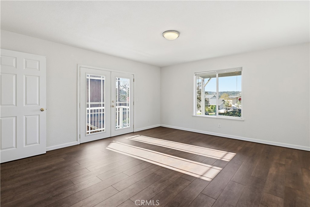 629 Poker Flat Road Copperopolis, CA 95228 - Photo 47 of 71 an empty room with wooden floor and windows