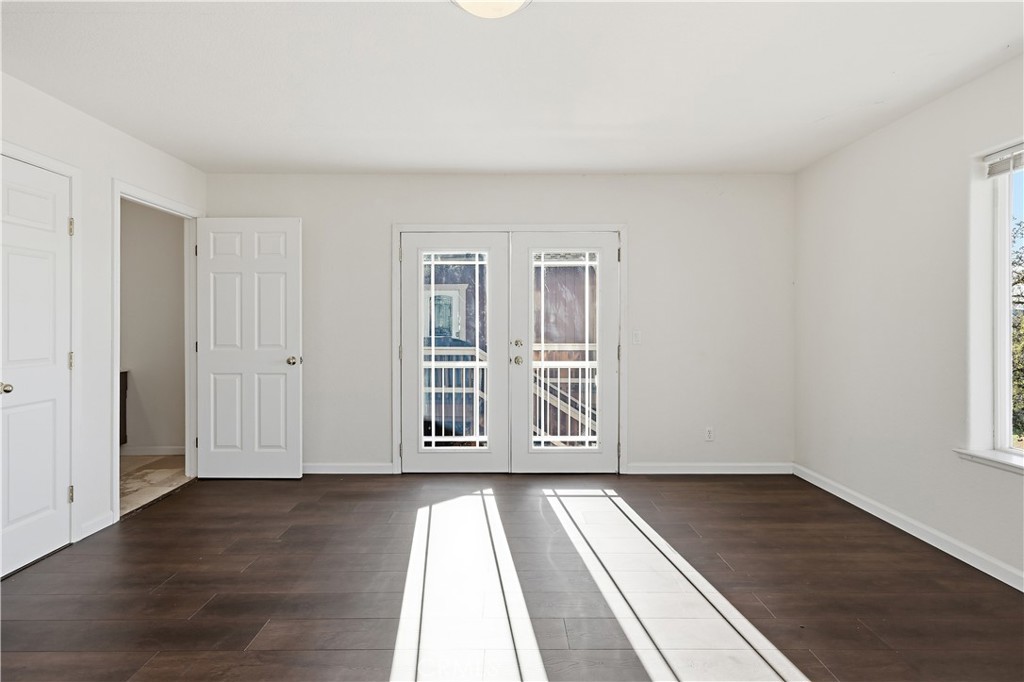 629 Poker Flat Road Copperopolis, CA 95228 - Photo 48 of 71 an empty room with wooden floor and windows
