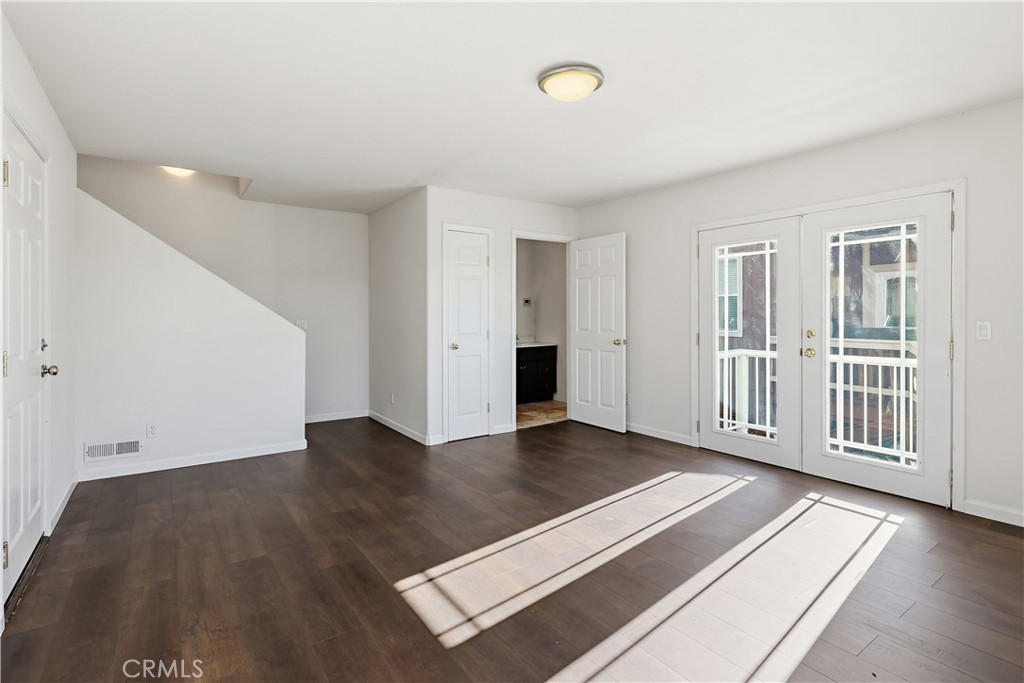 629 Poker Flat Road Copperopolis, CA 95228 - Photo 49 of 71 an empty room with wooden floor and windows