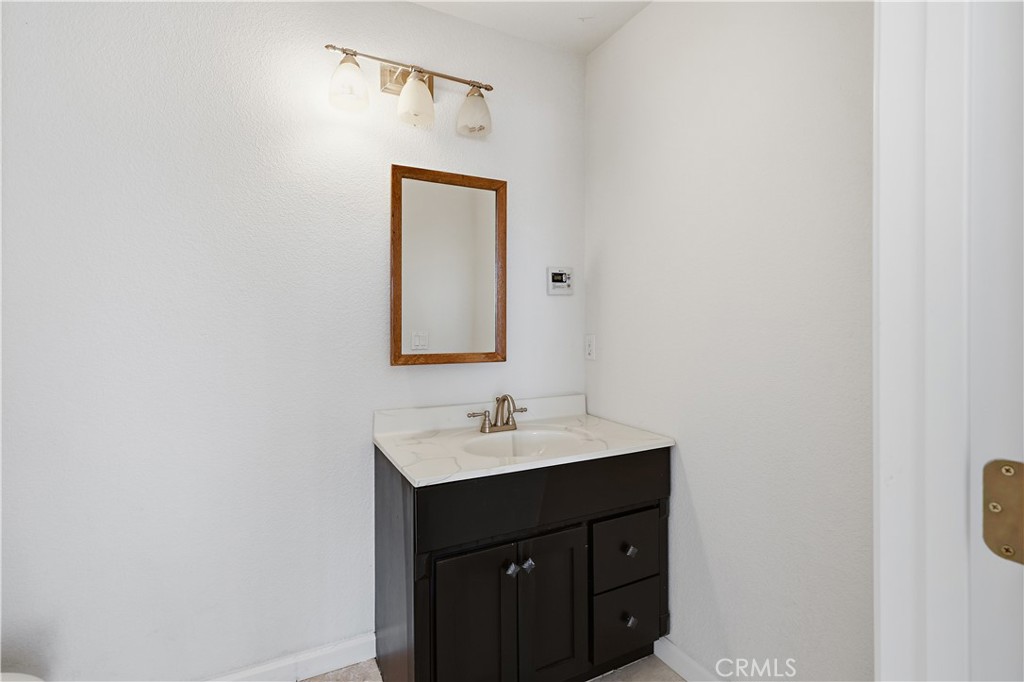 629 Poker Flat Road Copperopolis, CA 95228 - Photo 51 of 71 a bathroom with a sink vanity and a mirror