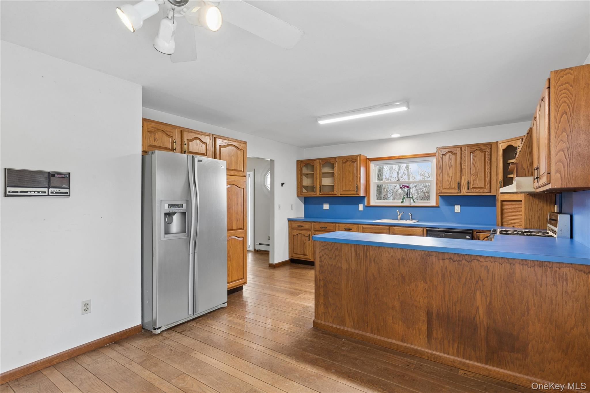 49 Overhill Road Wading River, NY 11792 - Photo 10 of 27 a large kitchen with stainless steel appliances granite countertop a refrigerator a stove and a wooden floors