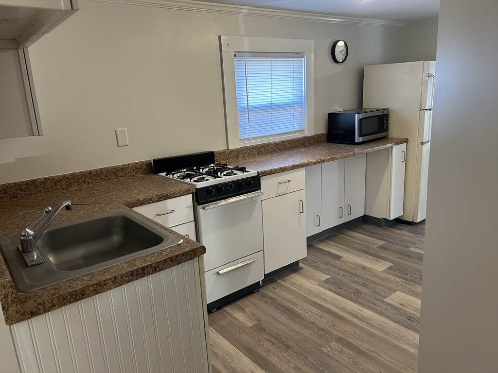 123 Sconticut Neck Road Fairhaven, MA 02719 - Photo 18 of 18 a kitchen with granite countertop a sink stove and cabinets