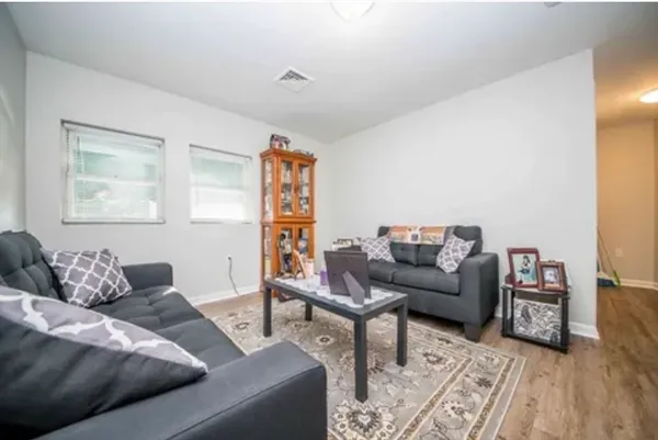 a bedroom with a bed and large window